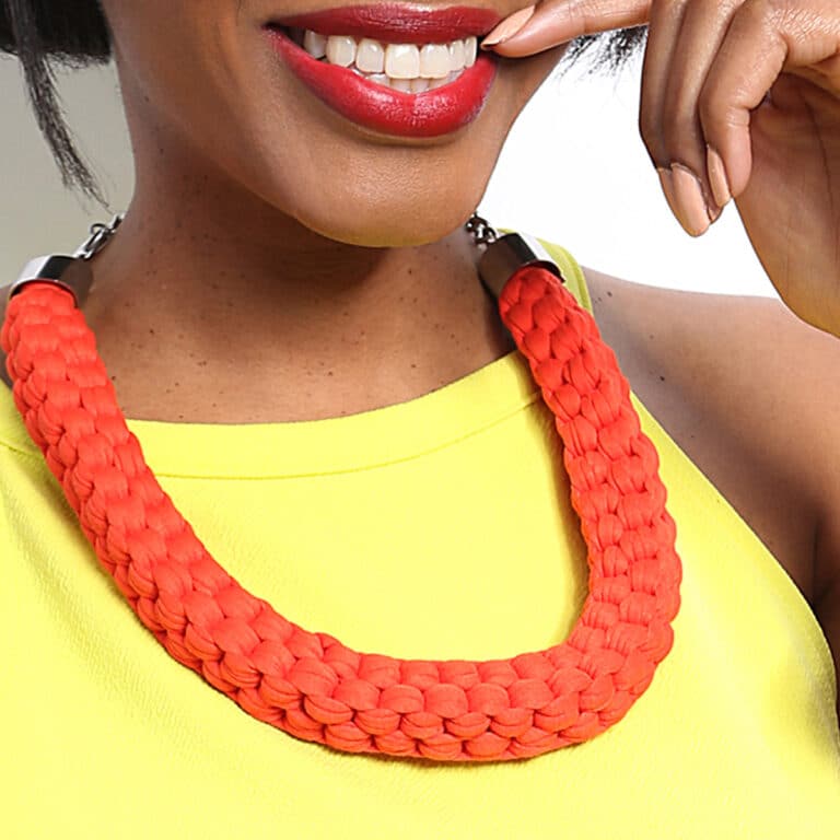 woman with braided necklace orange
